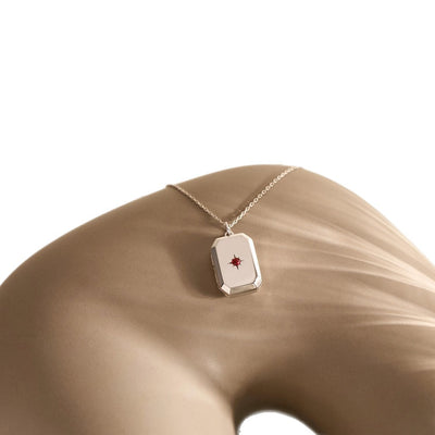 A Pendant Necklace With Birthstones Embedded In It